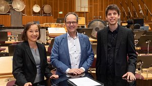 SWR-Intendant Kai Gniffke und Yuval Weinberg unterzeichnen den Vertrag in Anwesenheit der Chormanagerin Cornelia Bend. Bild: SWR / Alexander Kluge